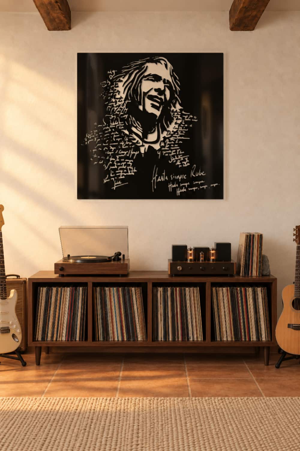 Cuadro Robe Iniesta de metal negro sobre un mueble de vinilos con tocadiscos en una casa de piedra